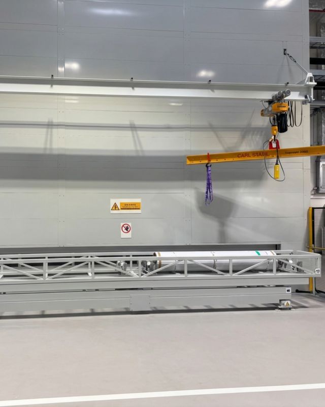 Fully enclosed Long Span Tower installation with integrated crane system for loading and unloading heavy cylindrical materials in a production environment
