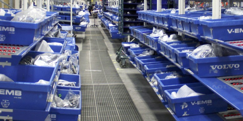 Blue plastic totes on carton flow system