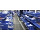 Blue plastic totes on carton flow system